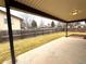 Covered patio overlooking backyard with a manicured lawn and wood fence at 6586 W Leawood Dr, Littleton, CO 80123