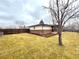 Spacious backyard featuring manicured lawn, mature trees, and a wood fence at 6586 W Leawood Dr, Littleton, CO 80123