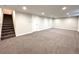 Spacious basement with neutral carpeting, recessed lights and easy access to stairs and utility closet at 6586 W Leawood Dr, Littleton, CO 80123