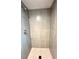 Modern tiled bathroom shower with sleek fixtures and a well-designed shower head at 6586 W Leawood Dr, Littleton, CO 80123