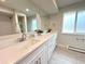 Elegant bathroom with double sink vanity, modern fixtures, large mirrors and great natural light at 6586 W Leawood Dr, Littleton, CO 80123