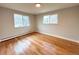 Bright bedroom with beautiful hardwood flooring and large windows for ample natural light at 6586 W Leawood Dr, Littleton, CO 80123