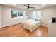 Bright bedroom featuring hardwood floors, neutral paint and a large window with backyard views at 6586 W Leawood Dr, Littleton, CO 80123