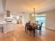 Modern dining room with hardwood floors, bright light, and an adjacent modern kitchen at 6586 W Leawood Dr, Littleton, CO 80123