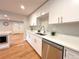 Bright kitchen featuring stainless steel appliances, modern white cabinets, and quartz countertops at 6586 W Leawood Dr, Littleton, CO 80123