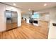 Spacious kitchen with stainless steel appliances and a large island open to the living area at 6586 W Leawood Dr, Littleton, CO 80123