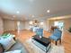 Open-concept home with hardwood floors connecting a living area, kitchen, and dining room at 6586 W Leawood Dr, Littleton, CO 80123