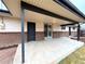 Spacious covered patio featuring brick accents, a sliding glass door, and stylish black trim at 6586 W Leawood Dr, Littleton, CO 80123
