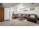Inviting basement featuring a comfortable couch, coffee table, and cozy decor at 12167 E Exposition Ave, Aurora, CO 80012