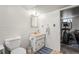 Efficient bathroom with a toilet, sink and vanity, and doorway with excercise equipment at 12167 E Exposition Ave, Aurora, CO 80012