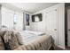 Cozy bedroom with a comfortable bed, ample natural light, and a TV at 12167 E Exposition Ave, Aurora, CO 80012