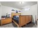Basement bedroom featuring a comfortable bed, dresser, and bedside table at 12167 E Exposition Ave, Aurora, CO 80012