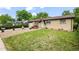 Beautiful brick home featuring a front yard with fresh green grass at 12167 E Exposition Ave, Aurora, CO 80012