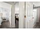 Hallway featuring paneled doors and a glimpse into the bedrooms at 12167 E Exposition Ave, Aurora, CO 80012