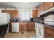 Functional kitchen with classic cabinetry and essential appliances at 12167 E Exposition Ave, Aurora, CO 80012