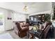 Comfortable living room with ceiling fan and large TV atop a fireplace console at 12167 E Exposition Ave, Aurora, CO 80012