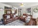 Inviting living room with plush leather seating and an open view to the kitchen at 12167 E Exposition Ave, Aurora, CO 80012