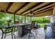 Charming covered patio with string lights and ceiling fan, perfect for outdoor entertaining at 12167 E Exposition Ave, Aurora, CO 80012