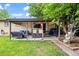 Cozy covered patio area with a grill and outdoor furniture for relaxing and entertaining at 12167 E Exposition Ave, Aurora, CO 80012