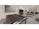 Spacious finished basement featuring a pool table, lounge area, and neutral decor, perfect for entertainment at 10763 Lewis Cir, Broomfield, CO 80021