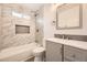 Modern bathroom with decorative tile, built-in shelves and updated vanity at 10763 Lewis Cir, Broomfield, CO 80021