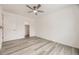 Bright bedroom featuring wood-look flooring, a ceiling fan and walk-in closet at 10763 Lewis Cir, Broomfield, CO 80021