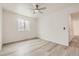 This bright bedroom features updated floors, white walls, and a ceiling fan at 10763 Lewis Cir, Broomfield, CO 80021