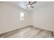 Bright bedroom featuring wood-look flooring, a ceiling fan and a window at 10763 Lewis Cir, Broomfield, CO 80021