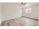 A bright bedroom with updated floors, white walls, and ample natural light at 10763 Lewis Cir, Broomfield, CO 80021