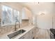This kitchen features stainless appliances, new backsplash, and updated flooring at 10763 Lewis Cir, Broomfield, CO 80021