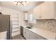 A bright kitchen showcases new backsplash, stainless appliances, and white cabinetry at 10763 Lewis Cir, Broomfield, CO 80021