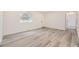 A spacious living room showcases updated floors, white walls, and bright, natural light at 10763 Lewis Cir, Broomfield, CO 80021