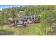 Aerial view of a home with spacious deck, surrounded by lush greenery at 25601 Centennial Trl, Golden, CO 80401