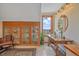 Bright bathroom features a glass sink, wooden vanity and storage cabinet, with a picturesque view of the mountains at 25601 Centennial Trl, Golden, CO 80401