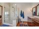 Modern bathroom featuring a glass shower, white marble and wooden vanity with a traditional sink at 25601 Centennial Trl, Golden, CO 80401