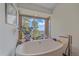 Relaxing bathroom features soaking tub with scenic views from the large window at 25601 Centennial Trl, Golden, CO 80401