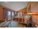 Cozy bedroom with a quilted bed, balcony access and outdoor view, complemented by unique lighting and furnishings at 25601 Centennial Trl, Golden, CO 80401