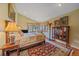 Inviting bedroom with large windows, an antique hutch, stylish lamps and a plush rug for comfort at 25601 Centennial Trl, Golden, CO 80401