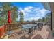 Outdoor deck with glass table, chairs, and ample seating area, ideal for enjoying the scenic mountain views at 25601 Centennial Trl, Golden, CO 80401
