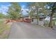 Exterior shot of a well-maintained home with a long driveway and mature trees at 25601 Centennial Trl, Golden, CO 80401