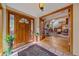 Bright foyer featuring hardwood floors, open view of living room, and front door with sidelights at 25601 Centennial Trl, Golden, CO 80401