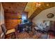 Cozy home office featuring wood paneling, a desk, and comfortable seating, creating a productive workspace at 25601 Centennial Trl, Golden, CO 80401