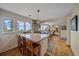 Open kitchen with granite island, stainless steel appliances, and picturesque outdoor views at 25601 Centennial Trl, Golden, CO 80401