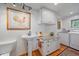 Well-organized laundry room features granite countertop and modern washer/dryer at 25601 Centennial Trl, Golden, CO 80401