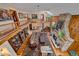 Spacious living room boasts wood floors, a stone fireplace, and elegant chandelier at 25601 Centennial Trl, Golden, CO 80401