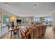 Open-concept living space with hardwood floors, doors to outside deck, and a well-lit kitchen at 25601 Centennial Trl, Golden, CO 80401