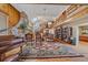 Spacious living room featuring a stone fireplace, wood accents, vaulted ceiling and second story loft at 25601 Centennial Trl, Golden, CO 80401