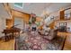 Bright living room with wood accents, stone fireplace, and a piano at 25601 Centennial Trl, Golden, CO 80401