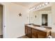 Bright bathroom features a double sink vanity, decorative starfish, and neutral finishes at 303 Diablo Pl, Brighton, CO 80603