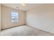 Neutral bedroom featuring a window with natural light and plush carpeting at 303 Diablo Pl, Brighton, CO 80603